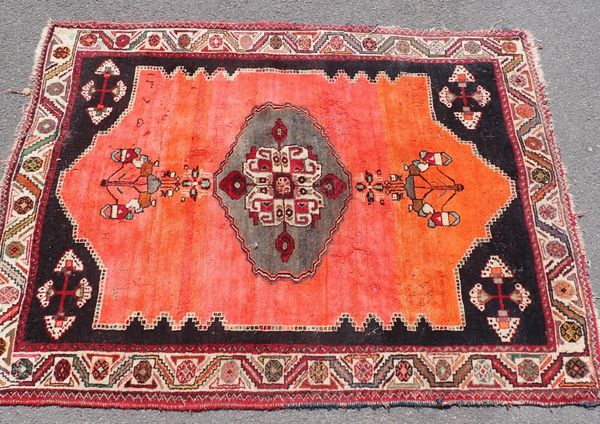 AN IRANIAN RED GROUND RUG