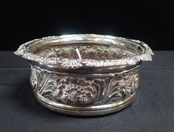 A GEORGE III SILVER BOTTLE COASTER
