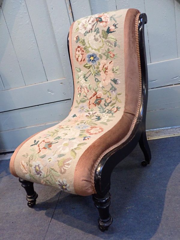 A VICTORIAN EBONISED SLIPPER CHAIR