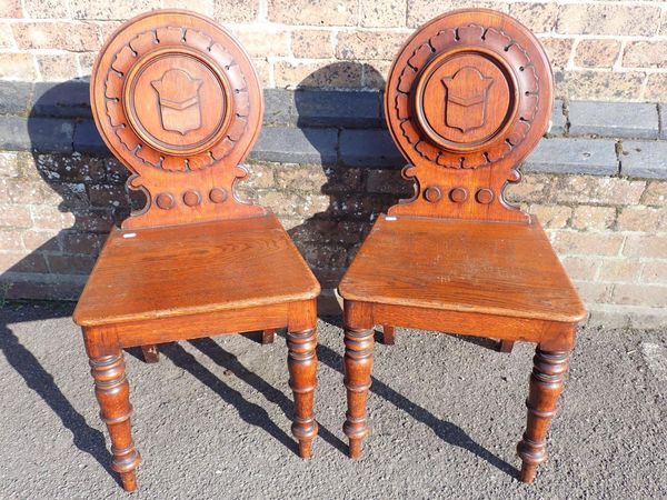 A PAIR OF VICTORIAN OAK HALL CHAIRS