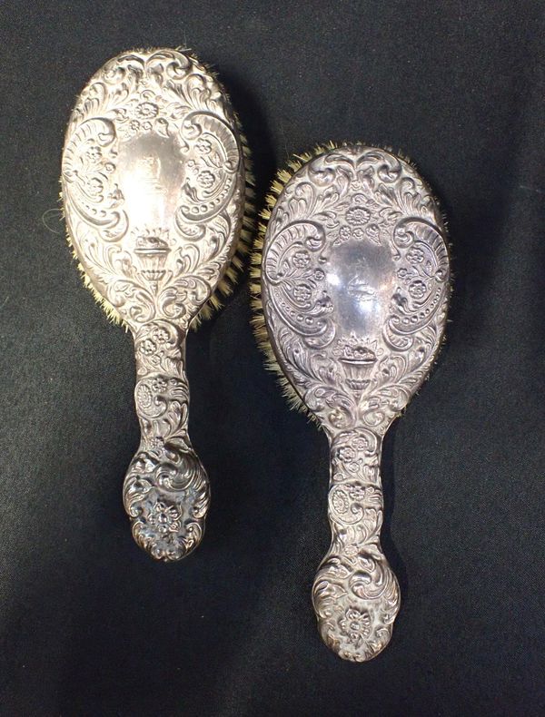 A PAIR OF SILVER MOUNTED HAIR BRUSHES