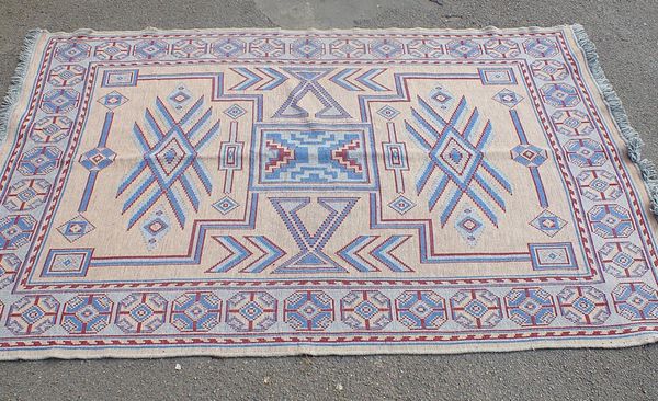 A FLATWEAVE RUG OR THROW