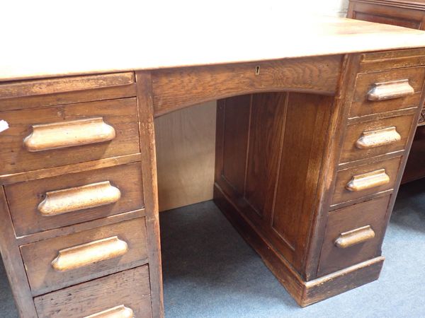 A 1920s OAK OFFICE DESK