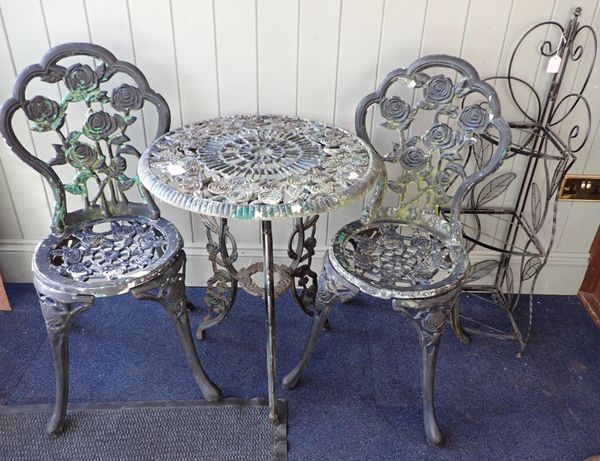 A VICTORIAN STYLE CAST METAL GARDEN TABLE AND TWO CHAIRS