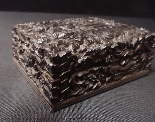 AN ASIAN CARVED HARDWOOD BOX AND COVER