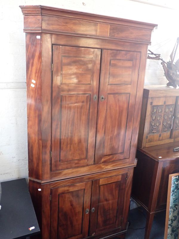 A GEORGE III MAHOGANY CORNER CUPBOARD