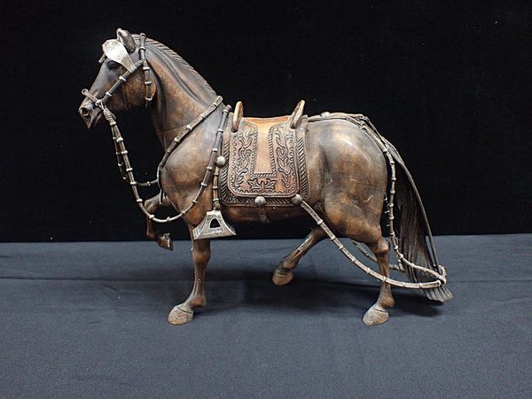 A PERUVIAN 950 SILVER-MOUNTED CARVED WOOD HORSE