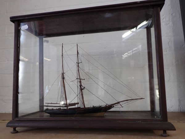 A WOODEN MODEL TWO-MASTED SAILING BOAT