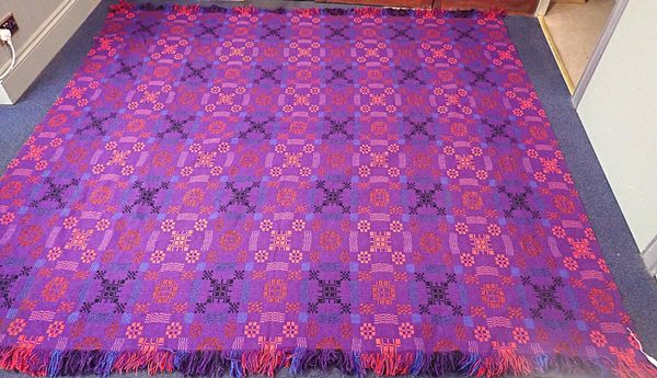 A 'HOLYTEX' WELSH BLANKET, IN RICH RED, BLUE AND PURPLE