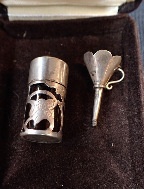 A 925 SILVER ENCASED PERFUME BOTTLE