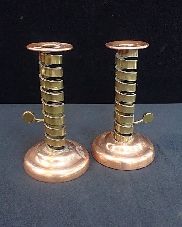 A PAIR OF ARTS & CRAFTS STYLE COPPER AND BRASS CANDLESTICKS