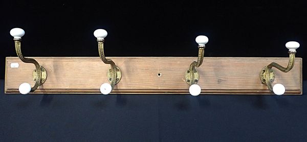 A SET OF FOUR VICTORIAN BRASS AND PORCELAIN COAT HOOKS