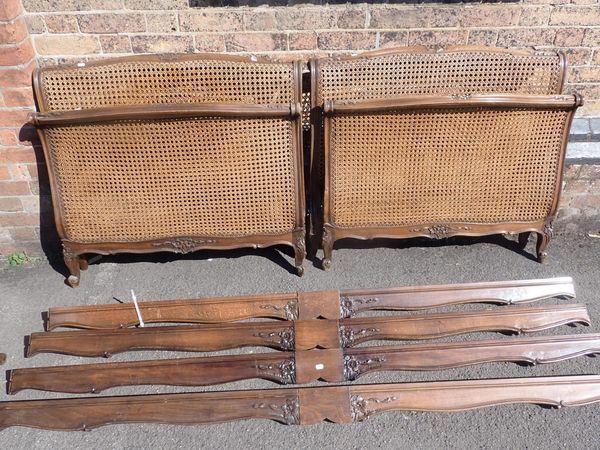 A PAIR OF SINGLE BEDS WITH LOUIS XV STYLE CARVED BEECHWOOD FRAMES