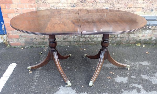 A REPRODUCTION MAHOGANY TWIN PILLAR DINING TABLE