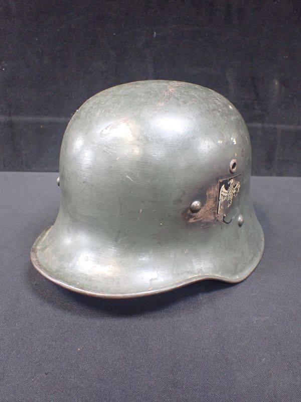 A WW1 M18 STYLE HELMET, RE-USED FOR WWII