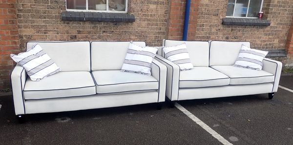 A PAIR OF MODERN TWO SEATER SOFAS