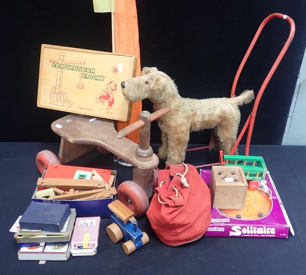 A CHILD'S PUSH ALONG PLUSH DOG AND A GOODWOOD WOODEN TRICYCLE