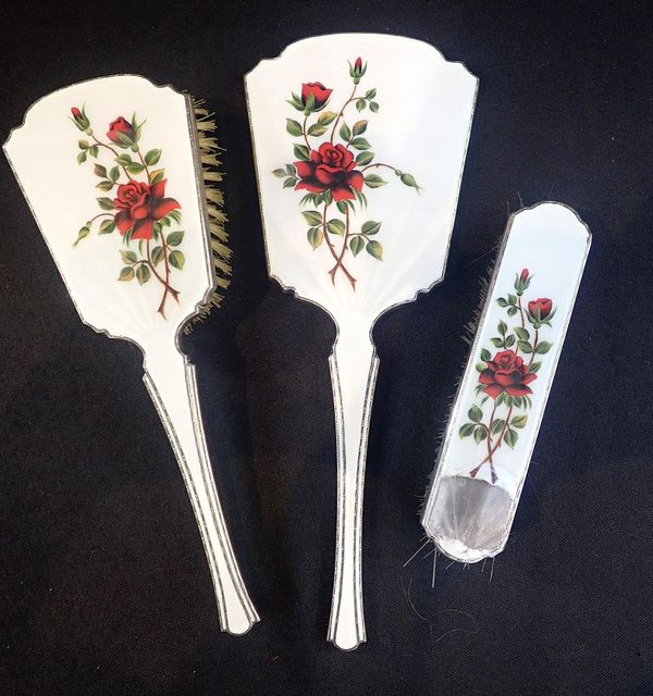 A SILVER THREE PIECE DRESSING TABLE SET