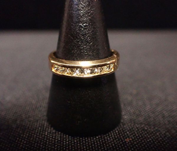 AN 18ct GOLD CHANNEL-SET DIAMOND HALF-ETERNITY RING