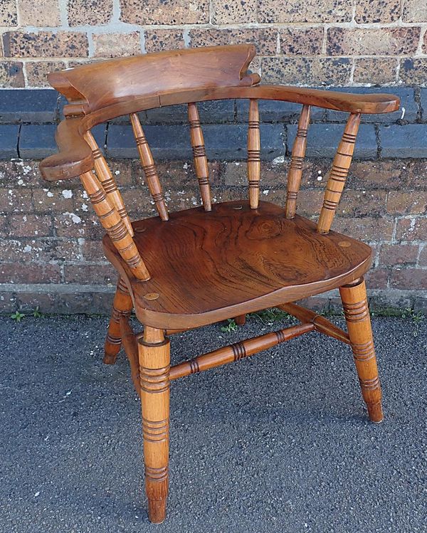 A LATE 19th CENTURY SMOKERS BOW ARMCHAIR