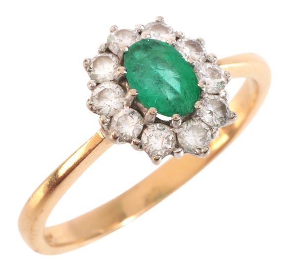 AN EMERALD AND DIAMOND CLUSTER RING