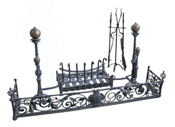 AN ARTS AND CRAFTS IRON FENDER, FIRE BASKET, AND ANDIRONS