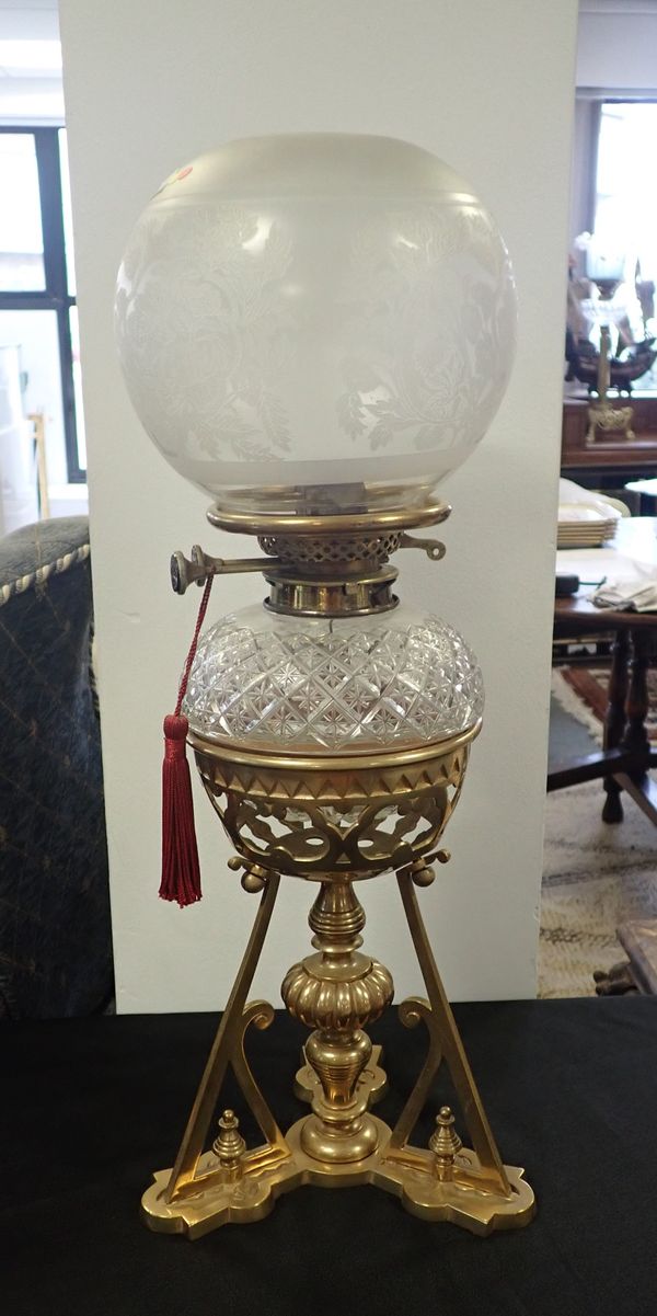 A 19TH CENTURY BRASS TABLE OIL LAMP OF ‘GOTHIC’ DESIGN