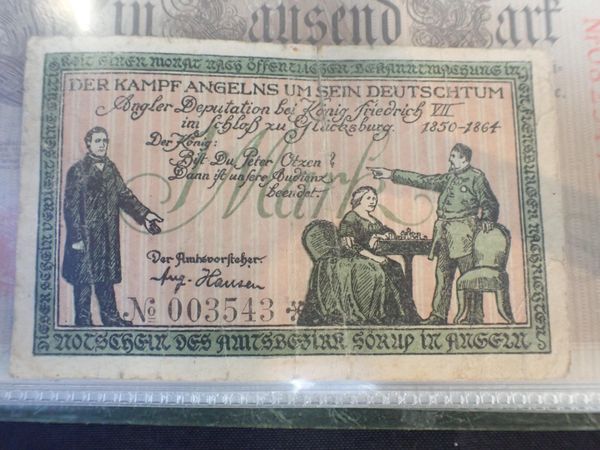 AN ALBUM CONTAINING AN ASSORTMENT OF GERMAN BANKNOTES