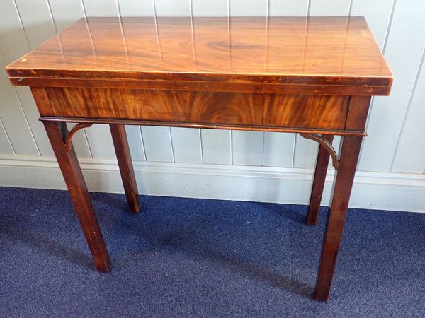 A GEORGE III MAHOGANY CARD TABLE WITH PIERCED BRACKETS