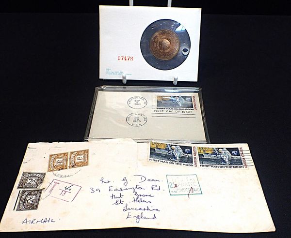 A 1969 MOON LANDING COMMEMORATIVE MEDAL AND STAMP