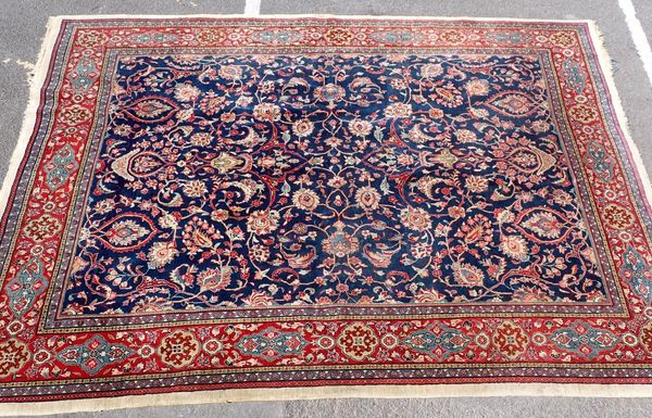 A LARGE RUG OF PERSIAN DESIGN