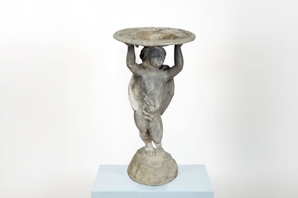 A LEAD BIRDBATH MODELLED AS A STANDING WINGED CHERUB