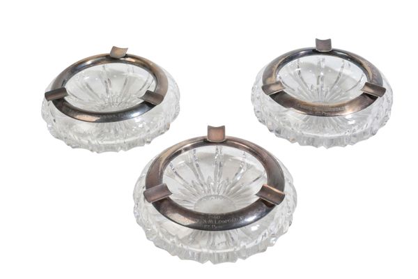 THREE CUT GLASS AND SILVER COLOURED PRESENTATION ASHTRAYS