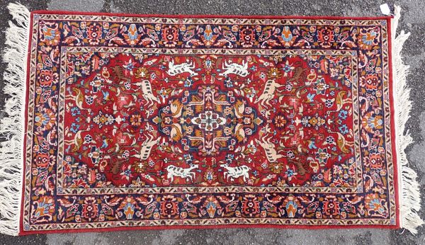 A PERSIAN HUNTING RUG, WITH LONG FRINGES