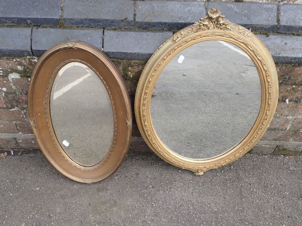 TWO OVAL GILT MIRRORS, THE LARGER WITH MOULDED DECORATION