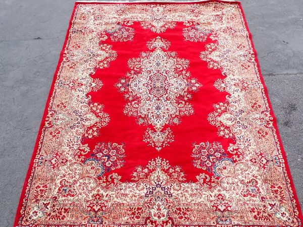 A LARGE MACHINE-MADE RUG