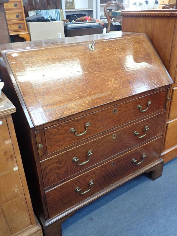 A GEORGE III FIGURED OAK BUREAU