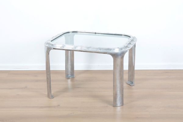 AN ALUMINIUM SHIP'S PORTHOLE CONVERTED TO A SIDE TABLE