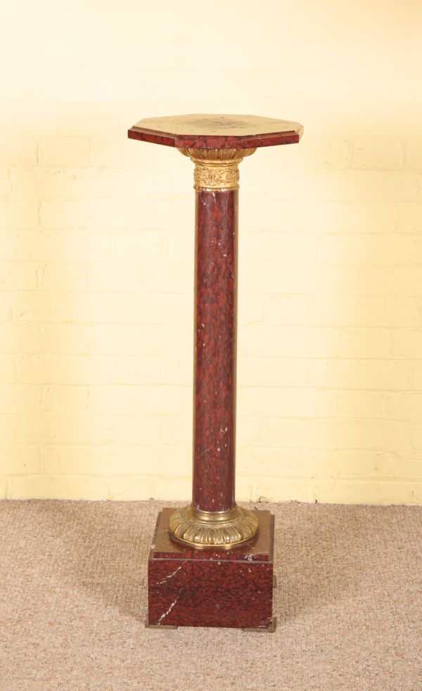 A ROUGE MARBLE AND GILT METAL MOUNTED TORCHERE