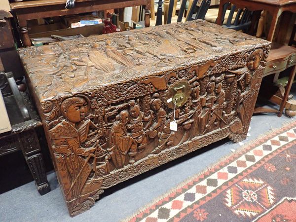 A CHINESE CAMPHORWOOD TRUNK, PROFUSELY CARVED