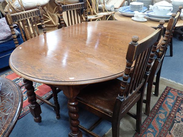 A 1920s OAK EXTENDING DINING TABLE WITH BARLEY-TWIST LEGS