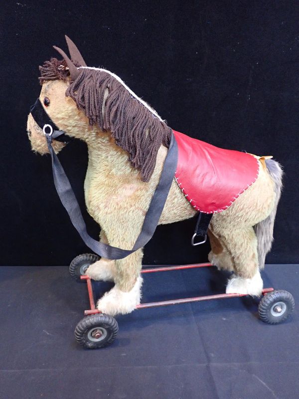 A PEDIGREE PULL-ALONG PLUSH PONY ON WHEELS