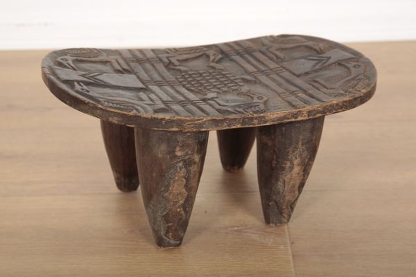 A SENUFO (WEST AFRICA) TRIBAL FOUR LEGGED STOOL