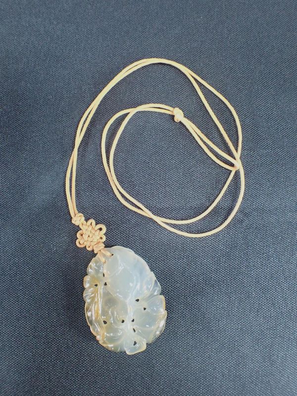 A CARVED JADE PENDANT