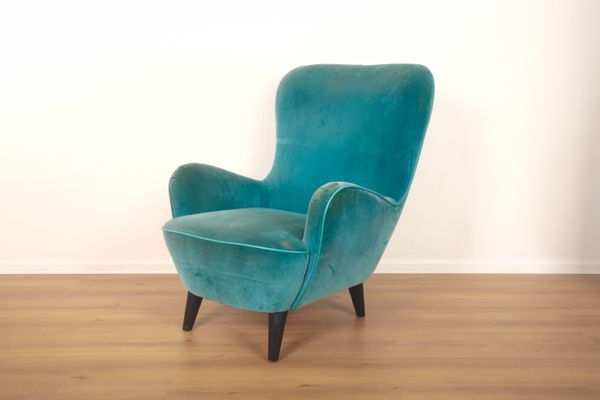 A WINGED ARMCHAIR BY FIBULE DE PARIS