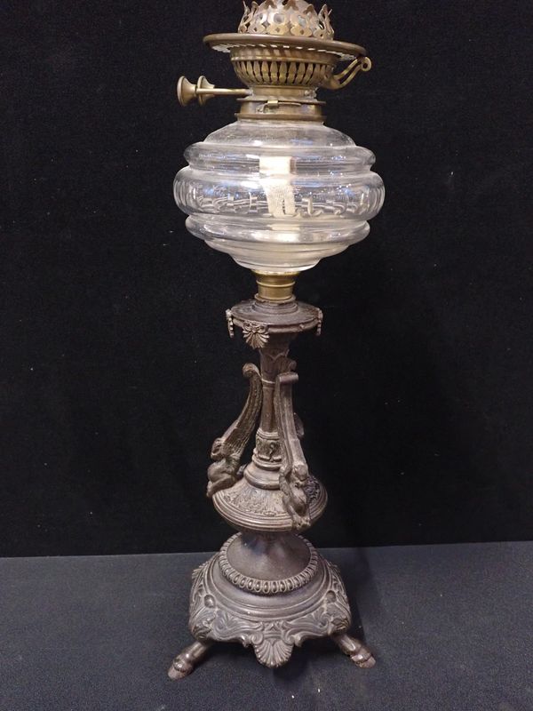 A VICTORIAN OIL LAMP WITH CAST IRON BASE