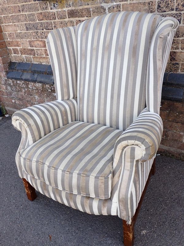 A GEORGE III STYLE WING ARMCHAIR