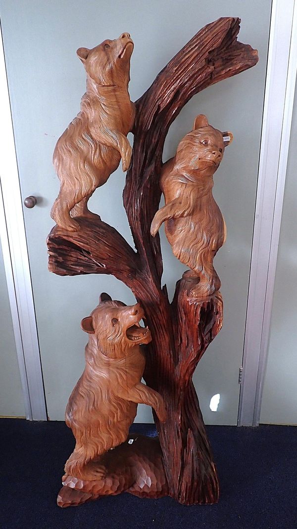 A LARGE CARVED WOODEN BLACK FOREST STYLE GROUP OF BEARS