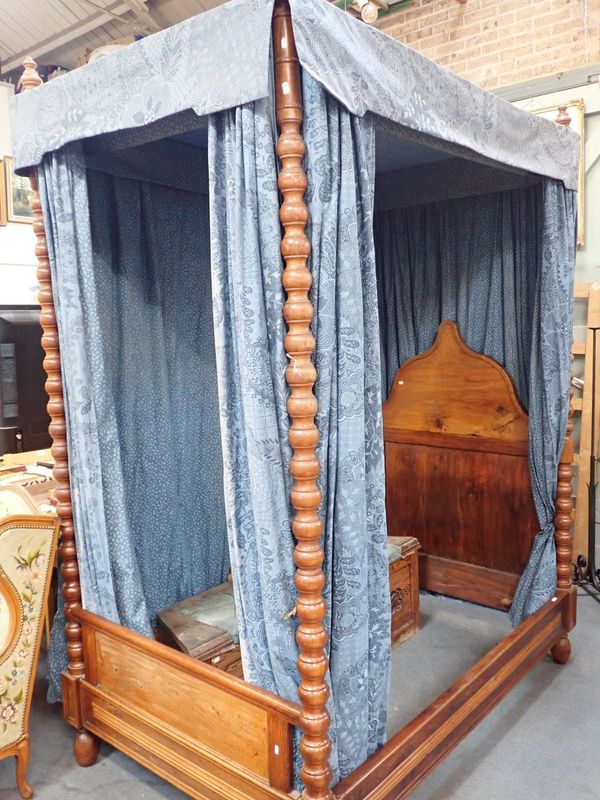 A CONTINENTAL WALNUT FOUR POSTER BED