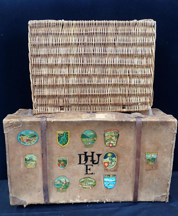 A VINTAGE LEATHER SUITCASE, WITH OLD LABELS